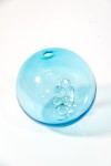 When sunlight shines through this azure blue glass globe, the colours are reminiscent of the waters of the Caribbean Sea. Image 2