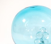 When sunlight shines through this azure blue glass globe, the colours are reminiscent of the waters of the Caribbean Sea. Image 4