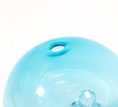 When sunlight shines through this azure blue glass globe, the colours are reminiscent of the waters of the Caribbean Sea. Image 5