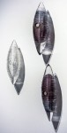 Three textured glass cocoon shapes in clear, charcoal grey and black are curated vertically in this unique wall sculpture by Julia Reimer. Image 8