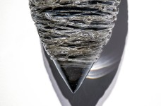 Thick threads of silver and clear on black glass create glinting texture in this unique wall sculpture by Julia Reimer. Image 3