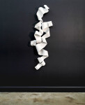 In bright white, ribbons of powder coated steel curl and ‘flow’ in this ethereal vertical wall sculpture by Stefan Duerst. Image 2