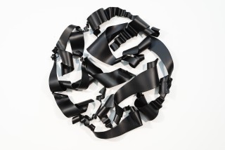 In elegant black, this expressive abstract wall sculpture was created by Stefan Duerst.
