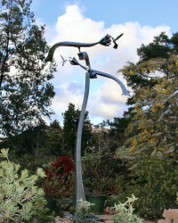 The magical and graceful flight of two hummingbirds is brought to life in this delightful stainless steel sculpture by Amos Robinson.