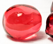 Clustered and sensuous oblong forms in translucent red glass have a smooth polished surface like the fruit that surrounds pomegranate seeds. Image 7