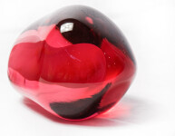 Clustered and sensuous oblong forms in translucent red glass have a smooth polished surface like the fruit that surrounds pomegranate seeds. Image 9