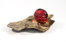 Luscious pomegranate red glass nesting in a bronze casing. Image 2