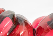 Clustered and sensuous oblong forms in translucent red glass have a smooth polished surface like the fruit that surrounds pomegranate seeds. Image 10