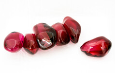 Clustered and sensuous oblong forms in translucent red glass have a smooth polished surface like the fruit that surrounds pomegranate seeds. Image 5