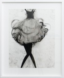 A torso in full tutu spins and twirls in black oil pastel beneath which protrude a misaligned pair of black knocked knee legs.