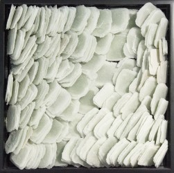 Layered petals of white glass frit are composed within a black lacquer frame by artist Cheryl Wilson Smith.