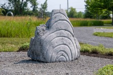 Concentric rings are carved on one side of this triangular chunk of limestone. Image 2