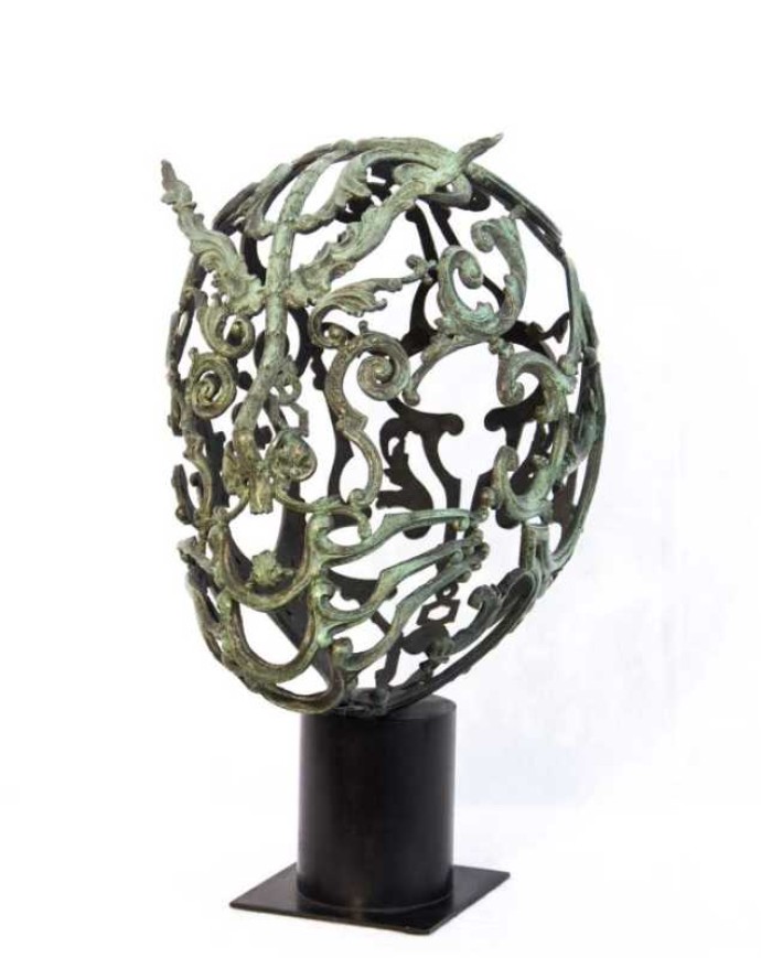 Bronze head fashioned from cast found objects - the decorative elements added to furniture early in the last century.
