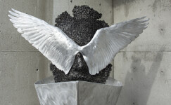 Old lead type, welded together to form the weathered face of this piece, is cast in aluminum. Image 2