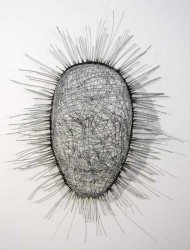 Strands of steel aircraft cable are woven into a silent, glittering mask by sculptor Dale Dunning.