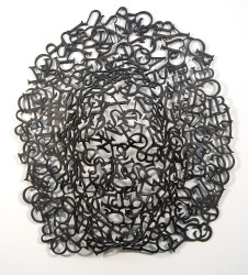This striking metal sculptural mask was created out of thoughts, words, and letters by Dale Dunning.