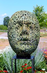 Letters, words, thoughts make up the form of this cast bronze human head by Dale Dunning.