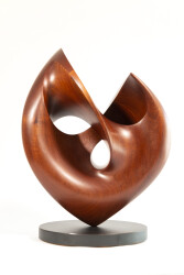 The graceful curves of this contemporary solid mahogany sculpture by David Chamberlain appear to emulate the image of a heart.