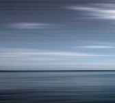 Various shades of steel grey and prussian blue stretch horizontally across this calming seascape.This image was taken with a slow shutter sp… Image 2