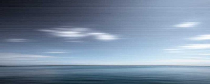 Various shades of steel grey and prussian blue stretch horizontally across this calming seascape.This image was taken with a slow shutter sp…