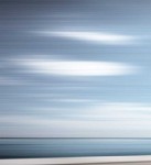 The soft tones of a cerulean sky reflected in pale waters. Image 3