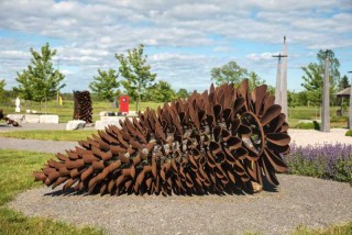 The steel Fire Cone, allowed to rust and take on the color of a pinecone, is, remarkably both an outdoor sculpture and a working fire pit.