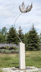 A delicately patterned leaf is caught up in the wind in this elegant steel sculpture by Canadian artist, Floyd Elzinga.
