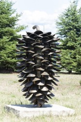 This outdoor stainless steel fire cone by sculptor Floyd Elzinga has a hinged lid that one opens with the curved stem handle.