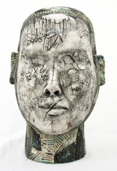 Graffiti tags and personalized marks form a narrative of rising waters in this dramatic ceramic bust by Irish sculptor Gráinne McHugh.