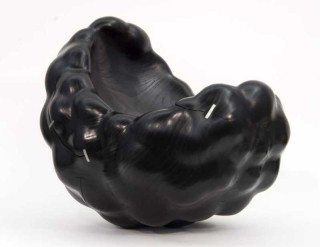 The polished wood of this hand-carved sculpture by artist Jana Osterman accentuates the sensual quality of this piece.