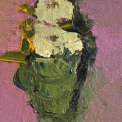 A bouquet of creamy coloured flowers in a sage green vase pops against a field of deep pink.