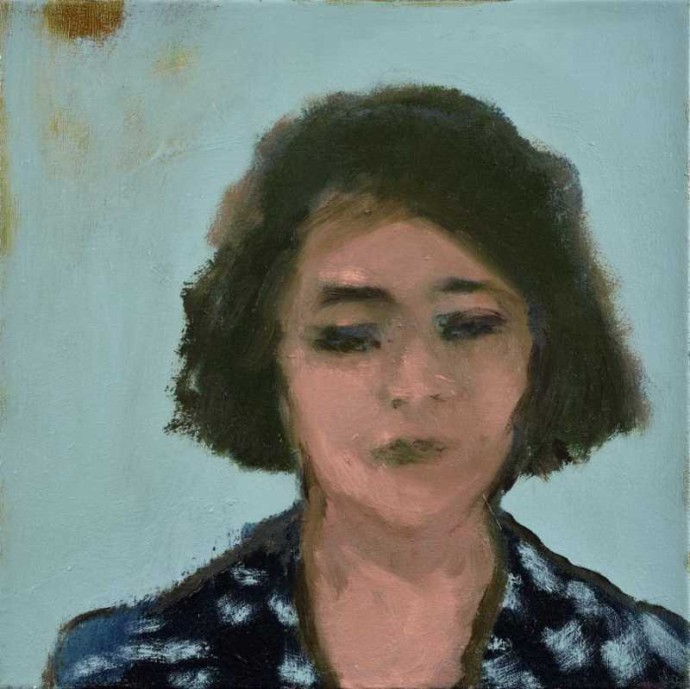 Small, intimate and incredibly emotive portrait of a woman in a blue patterned dress.
