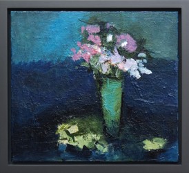 A vase full of soft pink and white flowers set in front of a turquoise and cerulean backdrop - or possibly sky.