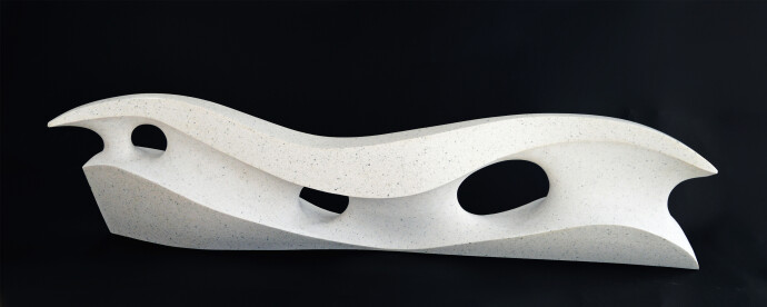 Smooth surfaced, engineered white marble sculpture flecked almost imperceptibly with grey has been sculpted into an elegant abstracted wave.
