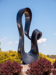 Smooth black granite engineered to resemble a time signature in music becomes an elegant outdoor sculpture by artist Jeremy Guy.