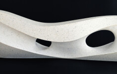 Smooth surfaced, engineered white marble sculpture flecked almost imperceptibly with grey has been sculpted into an elegant abstracted wave. Image 4