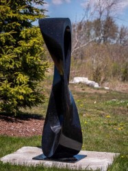 Smooth black granite has been engineered by Canadian artist Jeremy Guy into an elegant outdoor sculpture in the form of a mobius strip.