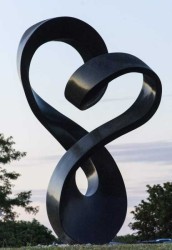 Smooth black granite has been engineered to resemble a treble clef in this elegant outdoor sculpture by Canadian artist Jeremy Guy.