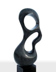 Smooth surfaced, black granite has been engineered into an elegant organic shape by sculptor Jeremy Guy.