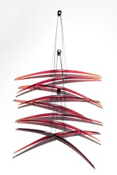 Elegantly curved deep red glass pieces in twos are suspended on fine black steel cables in this dramatic new wall sculpture by Canadian arti…