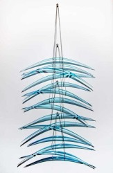 Elegantly curved aquamarine glass pieces in twos are suspended on fine steel cables in this stunning new wall sculpture by Canadian artist J…