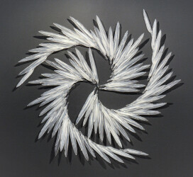 This exquisite glass wall sculpture extends almost 60 inches across.