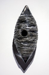 Thick threads of silver and clear on black glass create glinting texture in this unique wall sculpture by Julia Reimer.