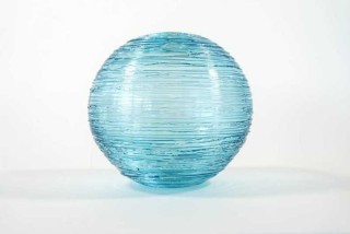Delicate ‘threads’ of glass reminiscent of the gossamer trail of a spider are spun into this elegant vessel by Canadian artist, Julia Reimer…
