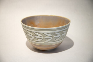 This exquisite, finely detailed ceramic vessel was created by Loren Kaplan.