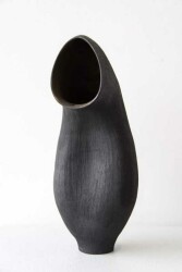 The elegant organic curves of this ceramic vessel in black by Loren Kaplan appear almost figurative.