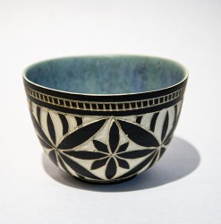 A beautiful black and white floral motif decorates the exterior of this exquisite little bowl by Loren Kaplan.