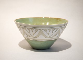 A lovely leaf motif in crisp white encircles this elegant bowl by Loren Kaplan.