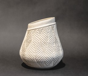 This delicately detailed vase in a creamy white is by Loren Kaplan.