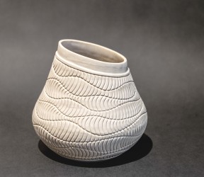 This delicately detailed vase in a creamy white is by Loren Kaplan.